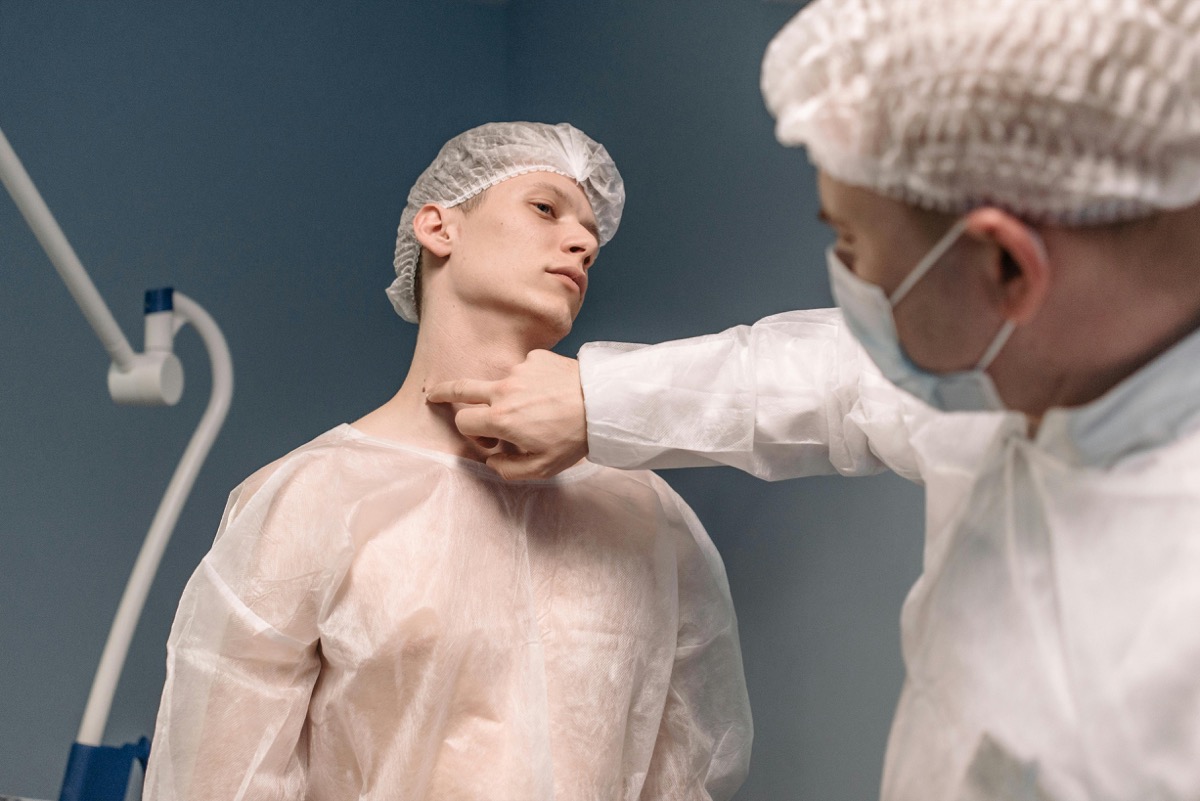 Doctor examining patient's neck for thyroid nodule evaluation