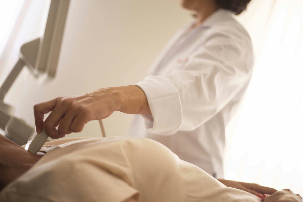 Physician examining neck before thyroid procedure — evaluating the right treatment option